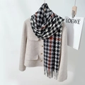Thick black white and red houndstooth scarf paired with a beige tweed jacket - Light Gray