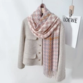 Houndstooth tassel scarf in pink and orange knit draped on a stylish blazer - Coral Pink