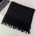 Solid black thick knitted winter scarf with long tassels and soft fuzzy texture - Black