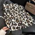 Classic leopard print cashmere scarf with frayed edges styled with a brown handbag - White Base Black