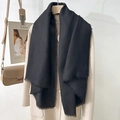 Elegant solid black scarf with delicate fringe tassels styled on a minimalist cream coat - Black (130 Frayed Solid Color) / Standard