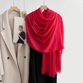 Solid vibrant red cotton linen scarf with soft fringe displayed over a beige wool coat - Sunny Red (41#)