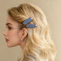 Detail view of denim texture hair clips with brown stitching on wavy blonde hair - 5.5cm (One Pair)