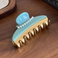 Sky blue acetate hair claw clip with white pearls and golden metal teeth on wood background - Blue-Large