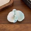 Elegant light cyan orchid hair clip with pearlescent finish and pearl center - Blue White