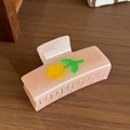 Pink acetate flower hair claw clip with yellow floral accent and glossy finish - Pink