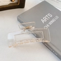 Minimalistische klare quadratische Haarklammer mit Goldfeder auf stylischem Buch - 10.5cm / Transparent Champagner