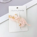 Pink translucent cat hair clip with gold glitter and acetate finish on white card - Transparent Pink