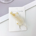 Cute white cat hair clip with pearlescent finish and golden details on display card - Iridescent White
