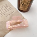 Pink marbled acetate hair claw clip with shell luster finish in lifestyle setting - Square / Orange