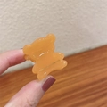 Amber bear-shaped acetate hair claw clip with golden France label engraving - Yellow Orange