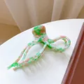 Elegante pinza per capelli oversize con motivo marmorizzato verde e bianco traforato - Verde Picchiettato - 13cm