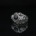 Vintage Gothic skull ring featuring a polished black onyx center stone and silver finish - US 7 / Steel Black