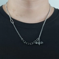 Gothic bat pendant necklace with irregular cuban chain shown on a male model - Antique Silver