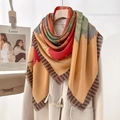 Floral print scarf with tassel edges and striped borders on a beige wool coat - Yellow