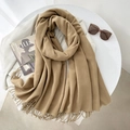 Classic camel cashmere-feel scarf with fringes laid on a white table for autumn style - 65*200cm / Khaki