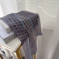 Detail of light blue silk scarf with vintage floral patterns on elegant book display - Blue Polka Dot