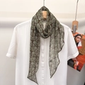Detail of silk scarf with green paisley floral patterns tied on a white shirt collar - Green Paisley