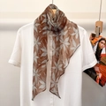 Elegant 100% silk skinny scarf with floral pattern draped on a white shirt - Caramel Maple Leaf