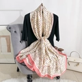 Elegant geometric print silk scarf in pink and cream, styled on a velvet chair - 180*90 / Pink Trim
