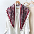 Classic paisley silk scarf in red and navy draped over a white shirt for a chic look - Red