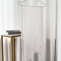 Polka dot silk scarf in white with black dots hanging on a pearl hook - Encounter White