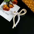 Elegant transparent bow hair claw clip with purple and yellow accents on black background - Large / Light Pink Nude