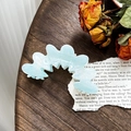 Elegant wavy light blue acetate hair claw clip with pearlescent finish on wood surface - Iridescent Blue (8.8cm)