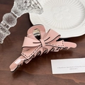 Pink acetate bow hair claw clip with black stitched edges on a wooden background - Pink-13cm