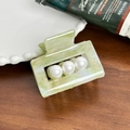 Pale green marble acetate hair claw clip with four pearls on dark wood background - 5.2cm / Cyan