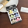 Set of 6 macaron heart hair clips in yellow, blue, and pink on a white plate - Set 8