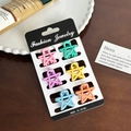 Set of six colorful macaron star-shaped hair clips in pink and mint on black card - Set 14