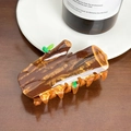 Brown wood-textured resin hair claw clip with realistic small green leaf accents - Tree Stump Claw