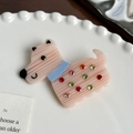 Pink puppy hair tie with colorful rhinestones displayed on a white decorative plate - Orange Red Hair Clip