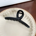 Matte black large hair claw clip for women on a decorative plate with wooden background - Black Ribbon - 12.8cm
