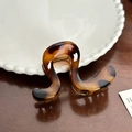 Elegant tortoiseshell acrylic hair claw clip with golden spring on a white ceramic plate - U-Shaped Coffee (8cm)