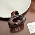 Glossy translucent dark brown heart-shaped hair claw clip on a vintage wooden table - Oval Grey (5.8cm)