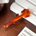 Floral acetate hair clip in orange gradient with amber finish and yellow crystal center - Caramel color