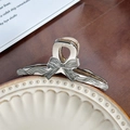 Chic beige hair claw clip with black polka dot bow patterns on a ceramic plate - Black Fine Lines Medium