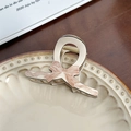 Pale gold metal hair claw clip with reddish-brown bow pattern in a ceramic dish - Coffee Fine Lines Small
