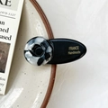 Barrette française avec base ovale noire et détail rond à texture marbrée - Noir et Blanc