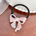 Pink marble texture acetate bow hair tie with black elastic band on wooden table - Blue Pink Marble Hair Tie