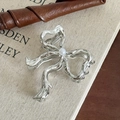 Silver liquid metal bow hair claw clip with pearl accent on a vintage aesthetic background - Silver Butterfly Bow with Pearl