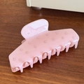Pink acetate hair claw clip with elegant rhinestones on a rustic wooden surface - 10.9cm / Pink