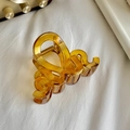 Elegant amber translucent wavy hair claw clip with gold spring on white fabric - Wave-Yellow / 8.1cm