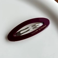 Barrette ovale en acétate bordeaux avec logo doré et clip métallique pour la coiffure - Style Creux Oval / Fuchsia