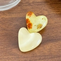 Translucent yellow and floral resin heart clips with gold foil on dark wood background - Solid Color and Dried Flower Combination / Beige