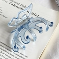Translucent light blue acetate butterfly hair claw clip on vintage French book - Blue With Gold Stamp