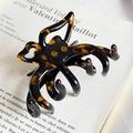 Elegant tortoiseshell acetate hair claw clip with golden label on a French magazine - Tortoise Without Label