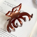 Elegant amber brown acetate butterfly hair claw clip on vintage book background - Brown No Label